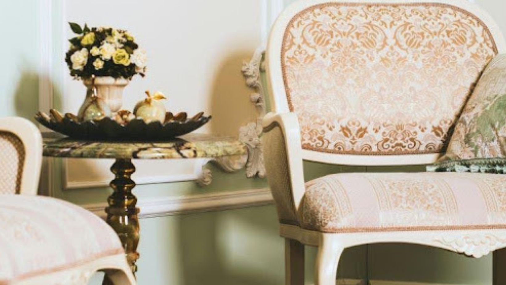 Vintage upholstered chairs and ornate side table.